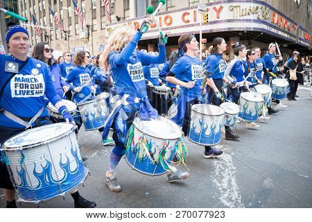 March For Our Lives: Women play drums in a drumline among other protesters in the march to end gun violence on 6th Ave, NEW YORK MAR 24 2018.
