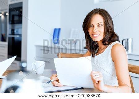 Woman with papers in their living room
