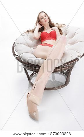 Beautiful Woman In Red Underwear Relaxing In A Round Chair Papasan .photo With Copy Space