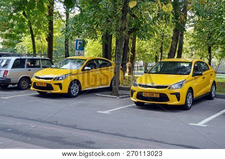 Moscow, Russia - September, 2018: Two Yellow Kia Rio Taxi Cars Are Parked In The Courtyard