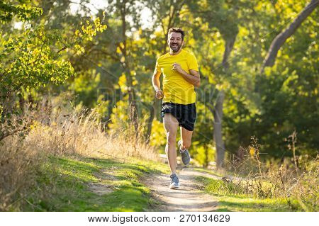 Athletic Young Man Running In The Nature At Sunset In Autumn In Fitness Healthy Lifestyle