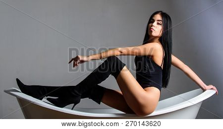 Girl Relaxed Sexy Pose Sit On Bathtub. Erotic And Desire. Fashion Sexy Model Seductive Posing On Bat