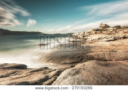 Long Exposure Image Of Waves Washing Onto Rocks On The Coast By The Genoese Tower At Punta Caldanu N