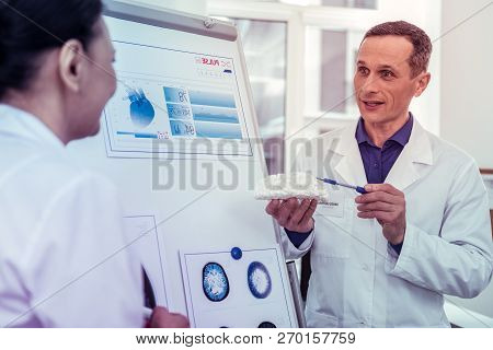Pleased Male Person Pointing At Artificial Brains