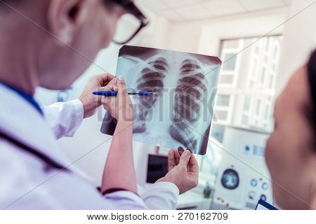 Close Up Of Female Hand That Pointing At Picture