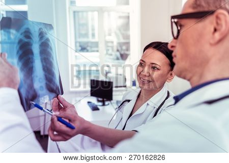 Pretty Asian Doctor Working With Pleasure In Clinic