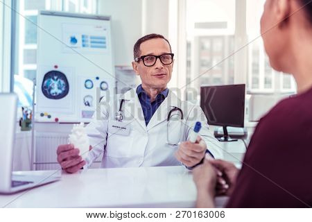 Positive Delighted Medical Worker Consulting His Patient