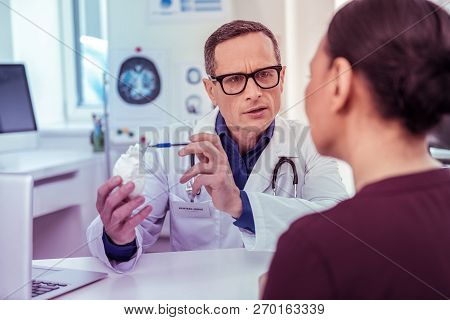Serious Practitioner Wrinkling Forehead During Important Talk