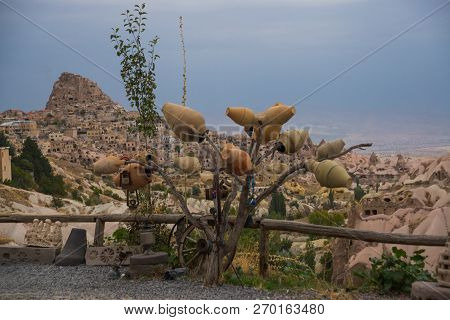 Cappadocia, Turkish: Tree With Pots On The Hill, In The Distance Is The City Of Uchisar