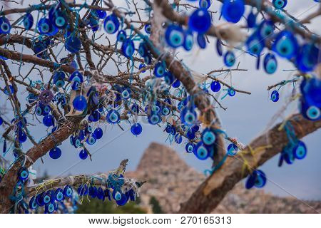 Evil Eye In Tree Behind Uchisar Castle In Cappadocia, Uchisar, Turkey.