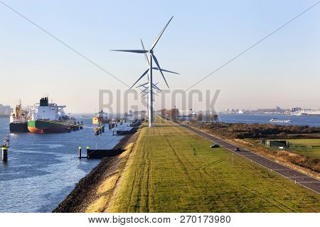 Ships Moored In The Canal Caland Near Turbines In The Port Of Rotterdam