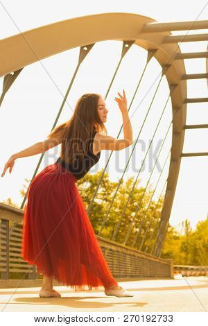 Young Slim Woman With Long Brown Hair Dancing