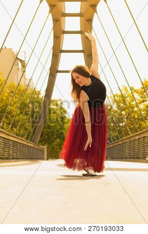 Young Slim Woman With Long Brown Hair Dancing