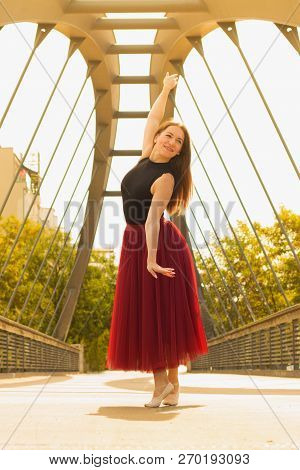 Young Slim Woman With Long Brown Hair Dancing