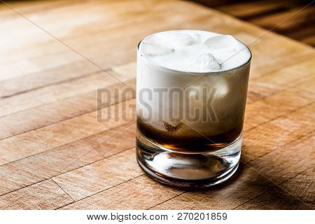White Russian Cocktail On Wooden Surface. Beverage Concept.