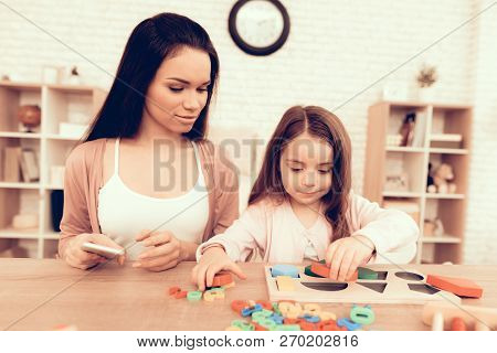 Mother Teaches Daughter. Educational Games. Learning Child At Home. Cubes And Puzzles. Child Develop