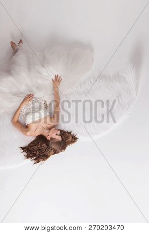 Girl In White Dress With Angel Wings On White Background. Angel-woman