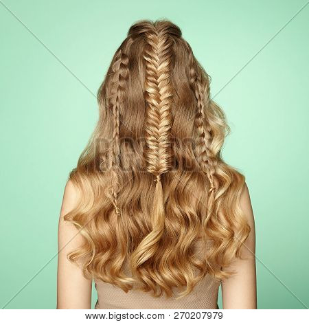 Blonde Girl With Long And Shiny Curly Hair. Beautiful Model Woman With Curly Hairstyle. Care And Bea
