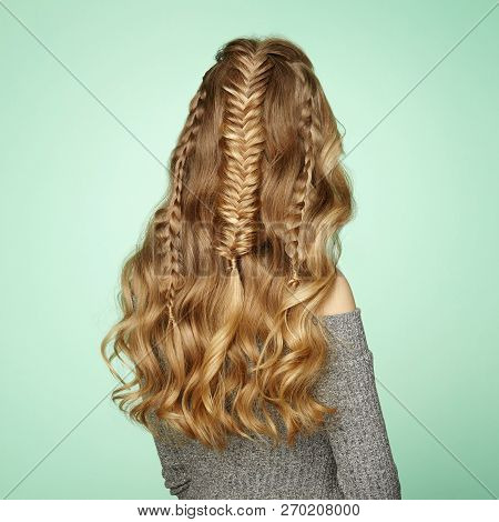 Blonde Girl With Long And Shiny Curly Hair. Beautiful Model Woman With Curly Hairstyle. Care And Bea