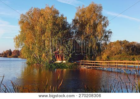 Scenic View Of Island With Abandoned House And Trees In The Middle Of The Lake. Autumn Morning Lands