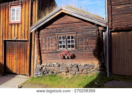 Dovetailed Brown Old Small Wooden House With Grass Covered Roof In The Norwegian Mining Town Of Roro
