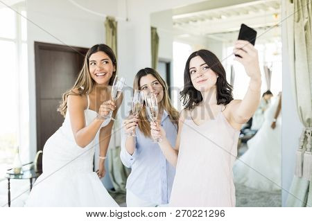 Best Friends With Content Bride Capturing Prewedding Memories In Clothing Store