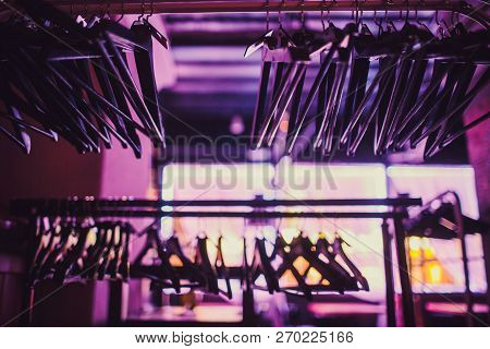 Stock Of Empty Clothes Hanger In Wardrobe, Wooden Coat Hangers Hanging On A Cloth Rail Rack In Close