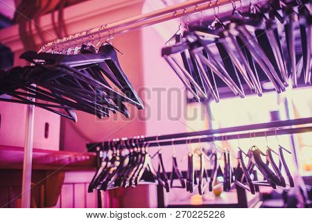 Stock Of Empty Clothes Hanger In Wardrobe, Wooden Coat Hangers Hanging On A Cloth Rail Rack In Close