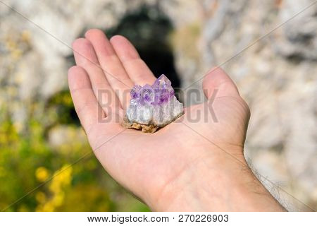 Druse Of Natural Untreated Violet Crystals Of Amethyst On A Piece Of Rock Lies On The Palm Of Your H