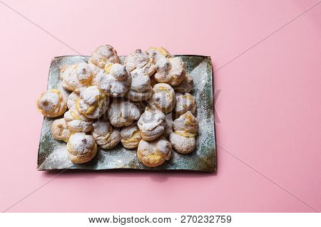 Homemade Profiteroles Served On A Plate In A Pink Background. Stock Image.