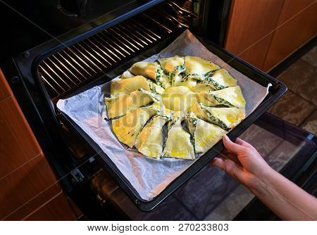 Woman Cooking In The Kitchen Puts A Raw Pie In The Oven. Closeup View. Stock Image.