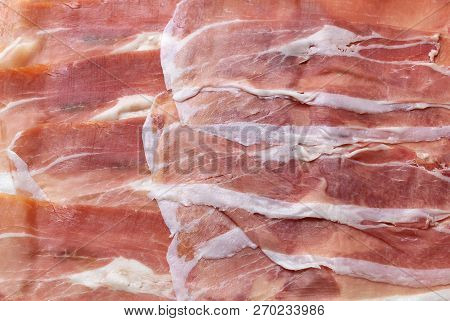 Sliced Italian Prosciutto Background. Meat Texture Closeup. Top View. Stock Image.