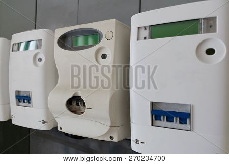 A Modern Digital Electric Meters On The Wall. Closeup View. Stock Image.