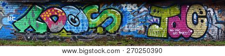 Full And Acomplished Graffiti Artwork. The Old Wall Decorated With Paint Stains In The Style Of Stre
