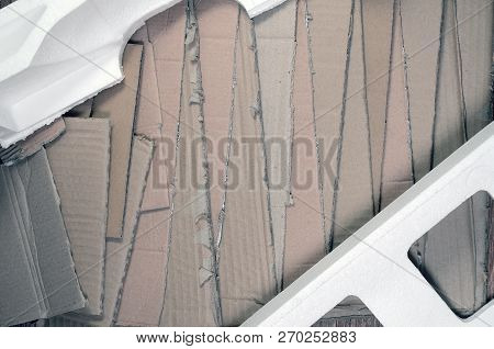 Background Image With A Lot Of Beige Cardboard Paper And Styrofoam Boxes Disgarded As Rubbish. The C