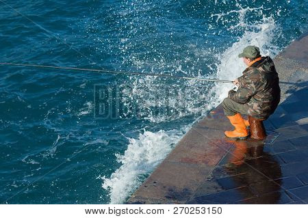 La Spezia Italy January 26 2014 A Fisherman On The Pier Of The Port In La Spezia City Challenges The