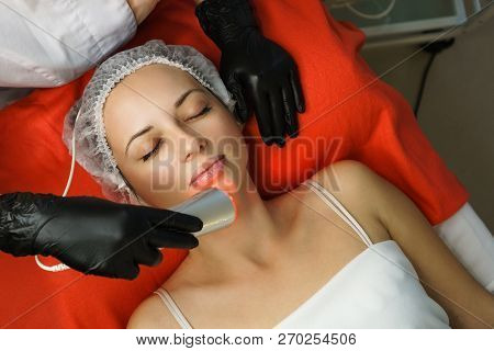 Hardware Cosmetology. Beautician Makes Ultrasonic Skin Tightening Client. Skin Pore Cleansing. Anti-