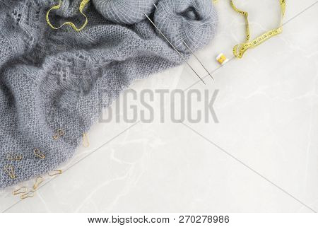 Knitting Background With Copy Space. Grey Knitwork With Metal Needles, Yellow Centimeter, Row Counte