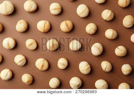 Flat Lay Composition With Shelled Organic Macadamia Nuts On Color Background