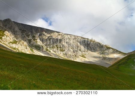 Photo Of Nature - Pretty Petrous Mountain Slope With Blue Sky