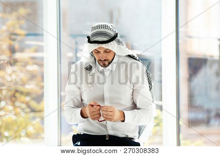 Muslim Man With Misbaha Praying Near Windows Indoors