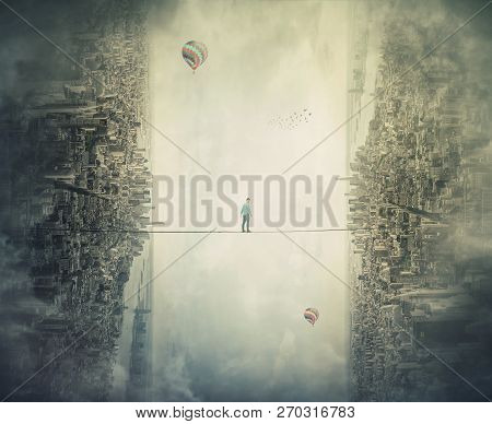 Young Man Silhouette Balancing On Slackline Rope High Above Clouds Between Two Imaginary Parallel Wo