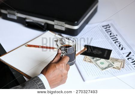 Businessman Holding Coffee With Briefcase
,passports And Dollars Put On Business Newpapers.