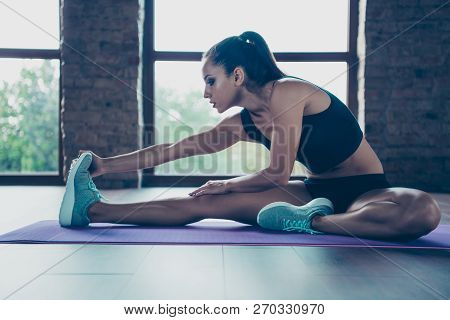 Profile Side View Of Nice Attractive Focused Sporty Brunette Girl Sitting On Carpet, Floor, Practici
