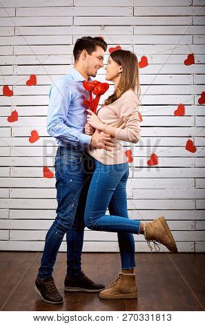Young Happy Couple With Heart In Hands Onbackground