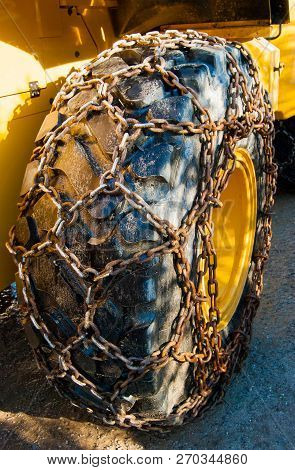 Large Wheel Of A Tractor With Mounted Snow Chains