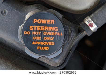 Cap Of A Power Steering Oil Tank. Do Not Overfill And Use Approved Fluid Only.