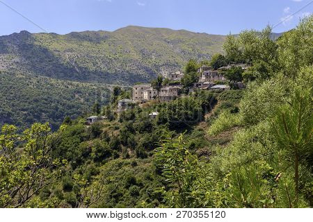 View Of The Traditional, Greek Village Kalarrytes Which Is On The Mountain Baros At An Altitude Of 1