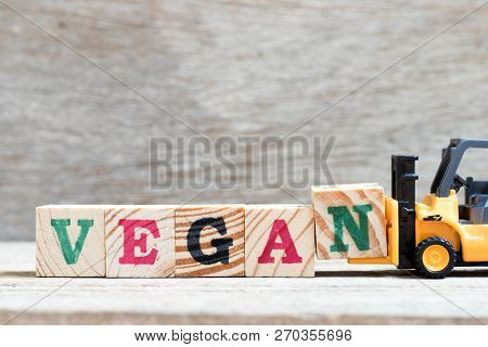 Toy Forklift Hold Lette Block N To Complete Word Vegan On Wood Background