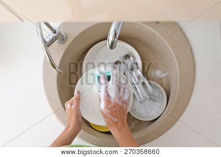 Woman Washing Dirty Dishes In Kitchen Sink, Top View. Cleaning Chores